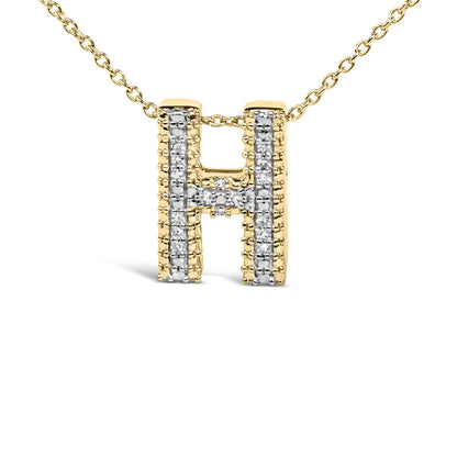 Close-up front view of a yellow necklace pendant in the shape of the letter 'H' adorned with white round gemstones in prong settings along its lines.