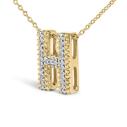 Close-up front angled view of a yellow metal necklace pendant shaped like the letter H, adorned with multiple white round gemstones in prong settings forming a cross pattern on the pendant.