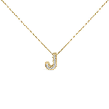 Close-up front angle of a yellow metal necklace with a pendant shaped like the letter J, featuring a row of white gemstones set in prongs along the pendant.