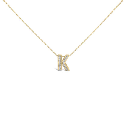 Close-up front angle of a yellow metal necklace with a pendant shaped like the letter K, adorned with round white gemstones in a prong setting on the pendant's front surface.