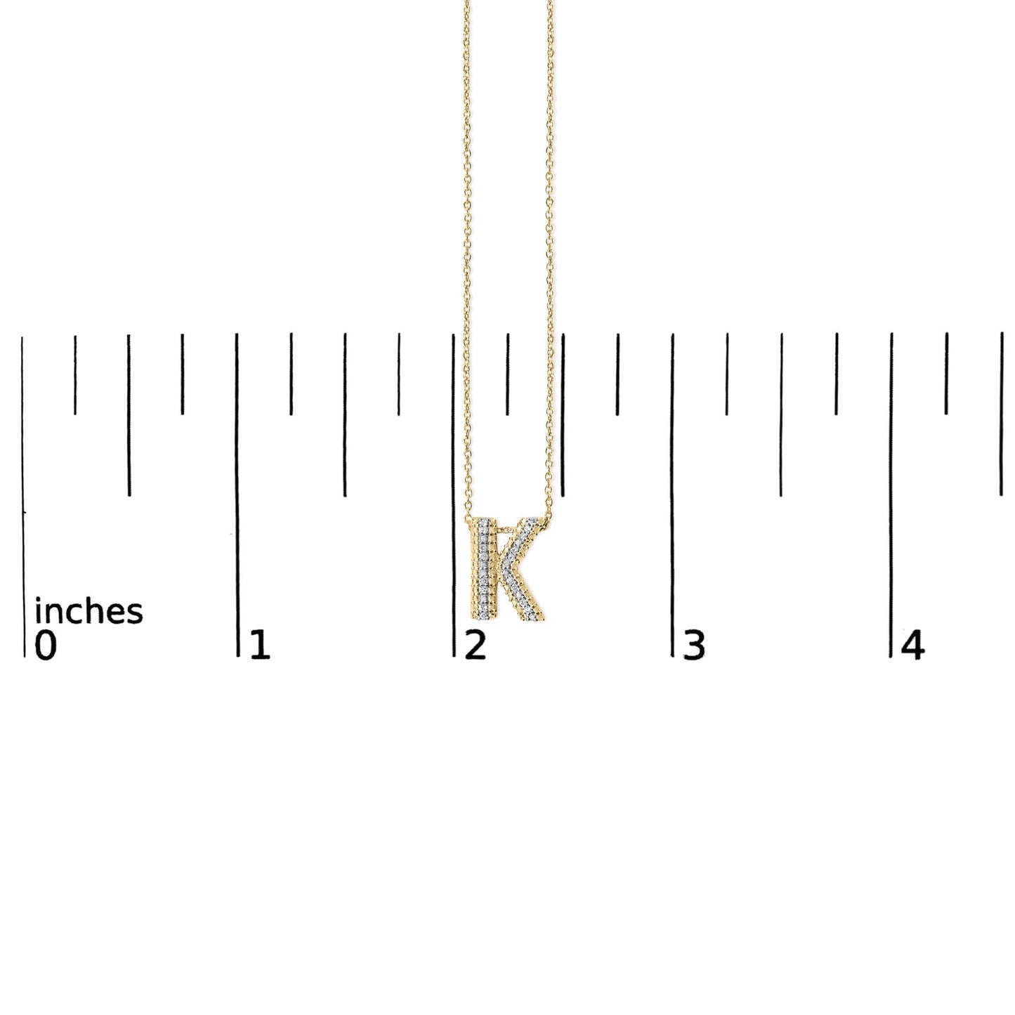 Close-up front view of a yellow necklace pendant in the shape of the letter K, adorned with white gemstones, shown hanging on a chain against a white background with measurement scale.