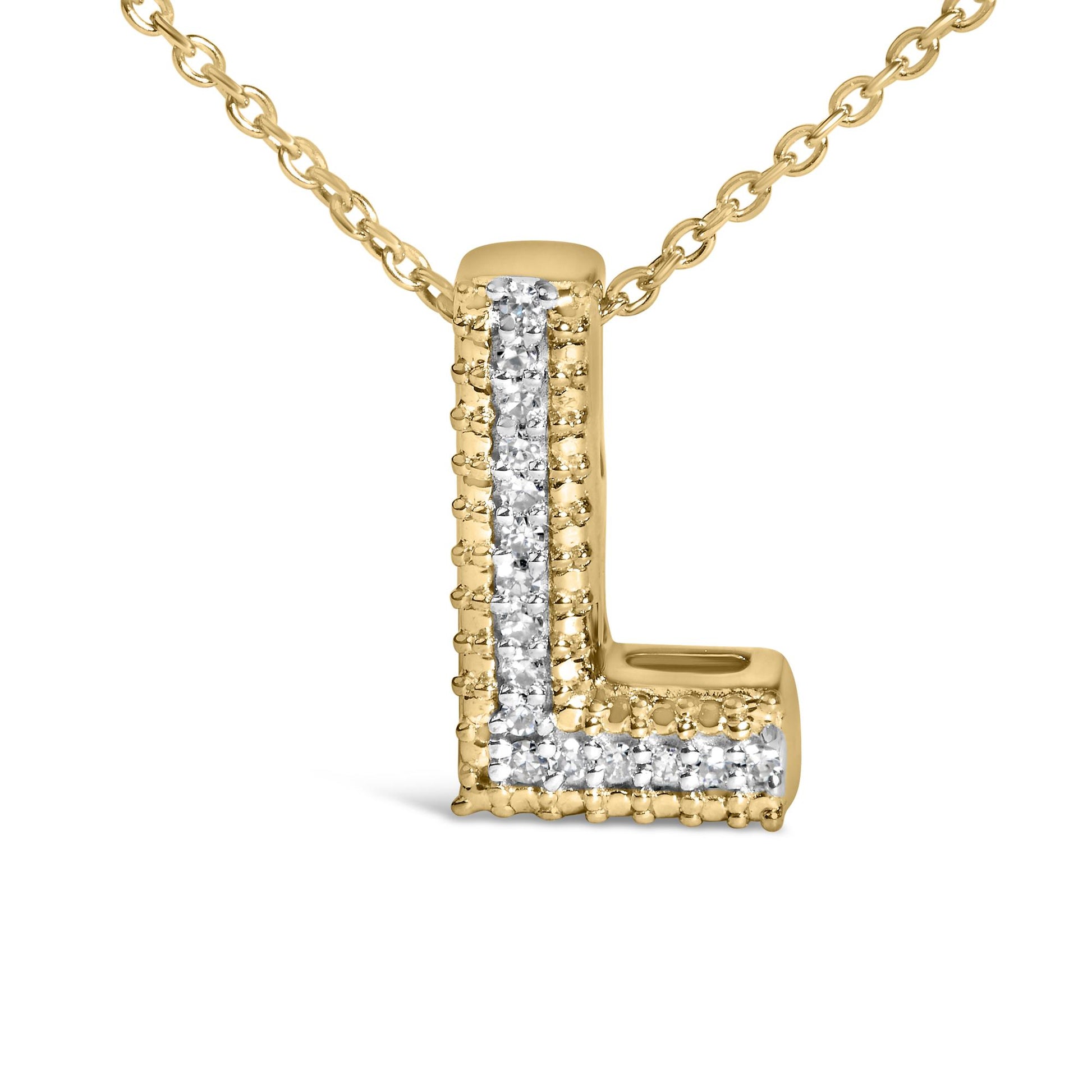 Close-up front angle of a yellow necklace pendant shaped like the letter L, adorned with a vertical and horizontal strip of white round gemstones in prong settings, shown on a white background.