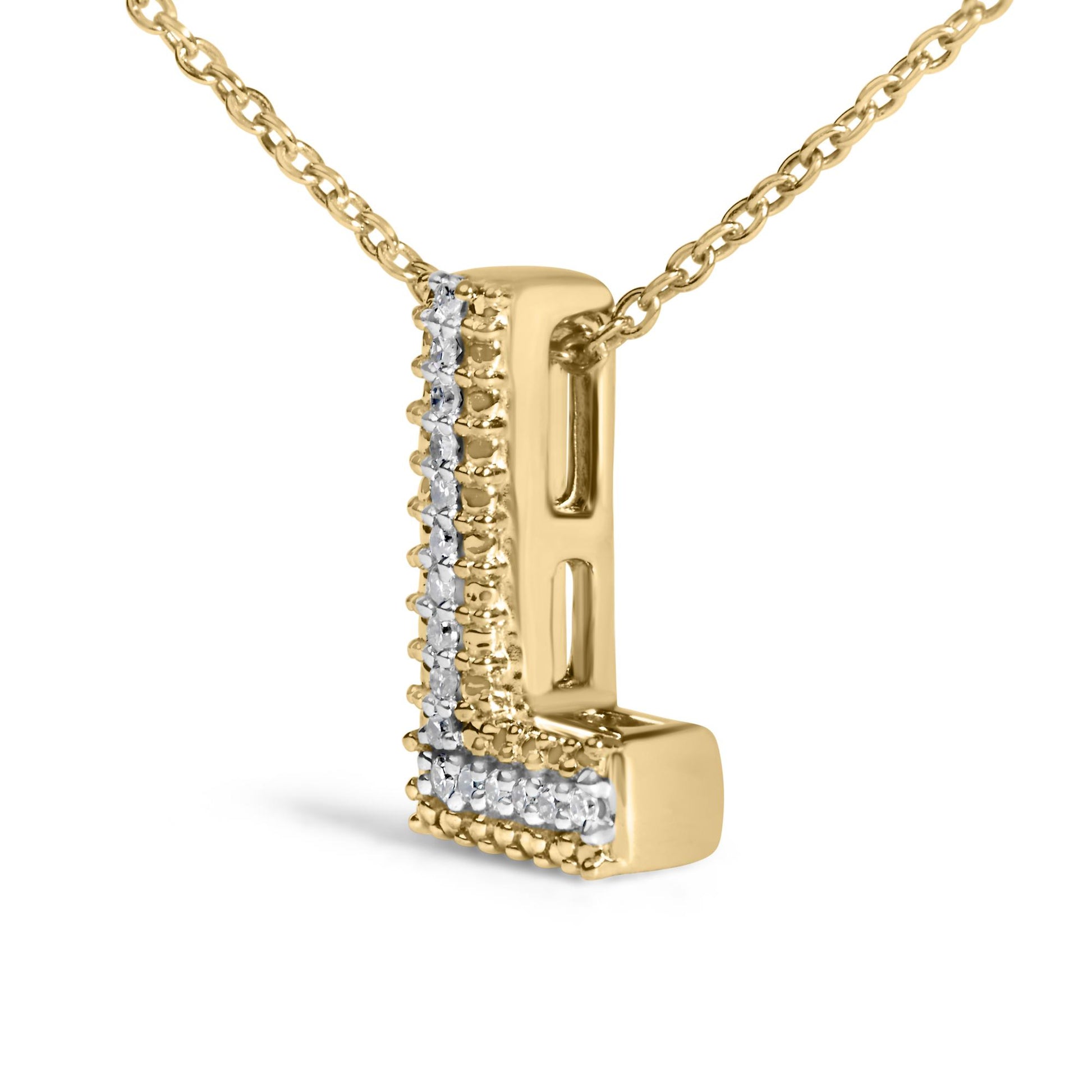 Close-up front angle of a yellow metal necklace pendant in the shape of the letter 'L' adorned with white round gemstones in prong settings along the vertical and horizontal edges.