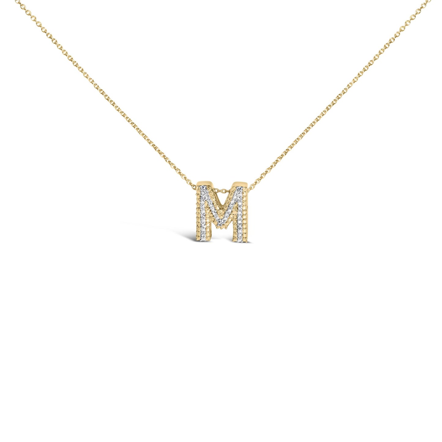Close-up front view of a yellow metal necklace with an 'M' pendant adorned with prong-set white gemstones, shown on a white background.