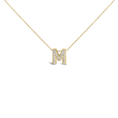 Close-up front view of a yellow metal necklace with an 'M' pendant adorned with prong-set white gemstones, shown on a white background.