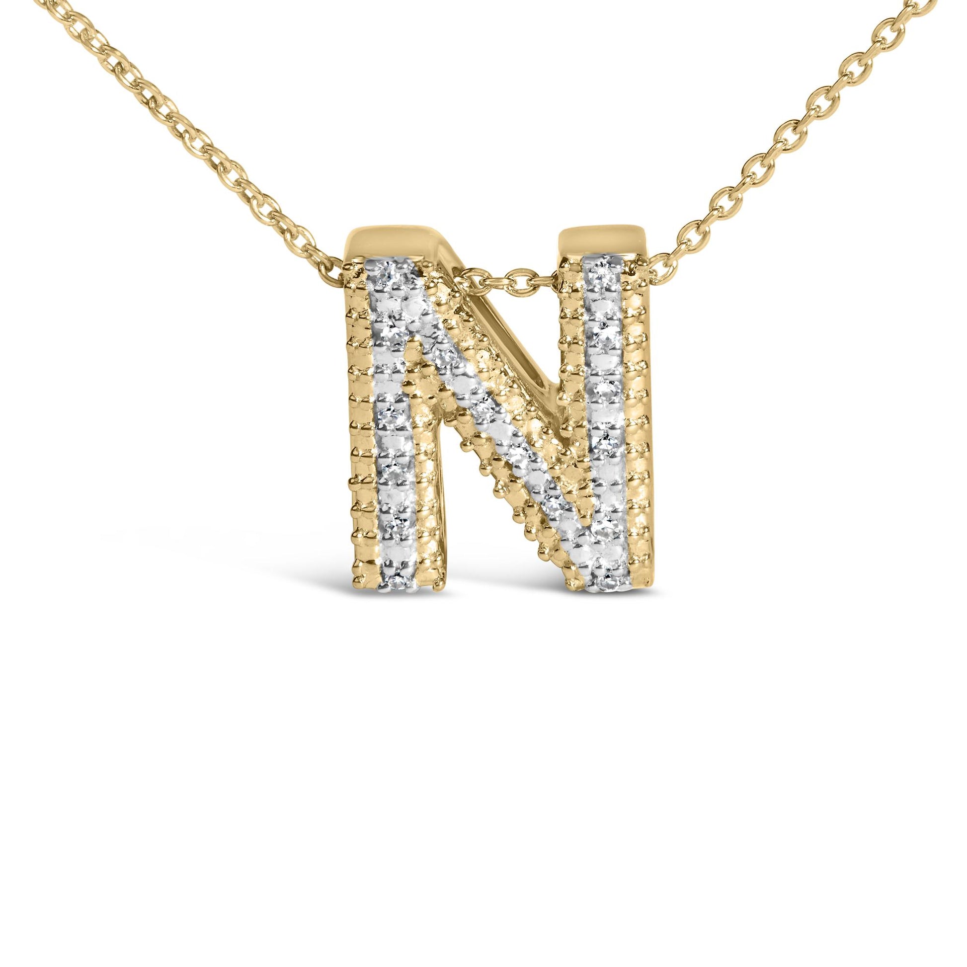 Close-up image of a yellow necklace pendant shaped as the letter N, detailed with white round gemstones in prong settings along the front, shown from a front-facing angle on a white background.