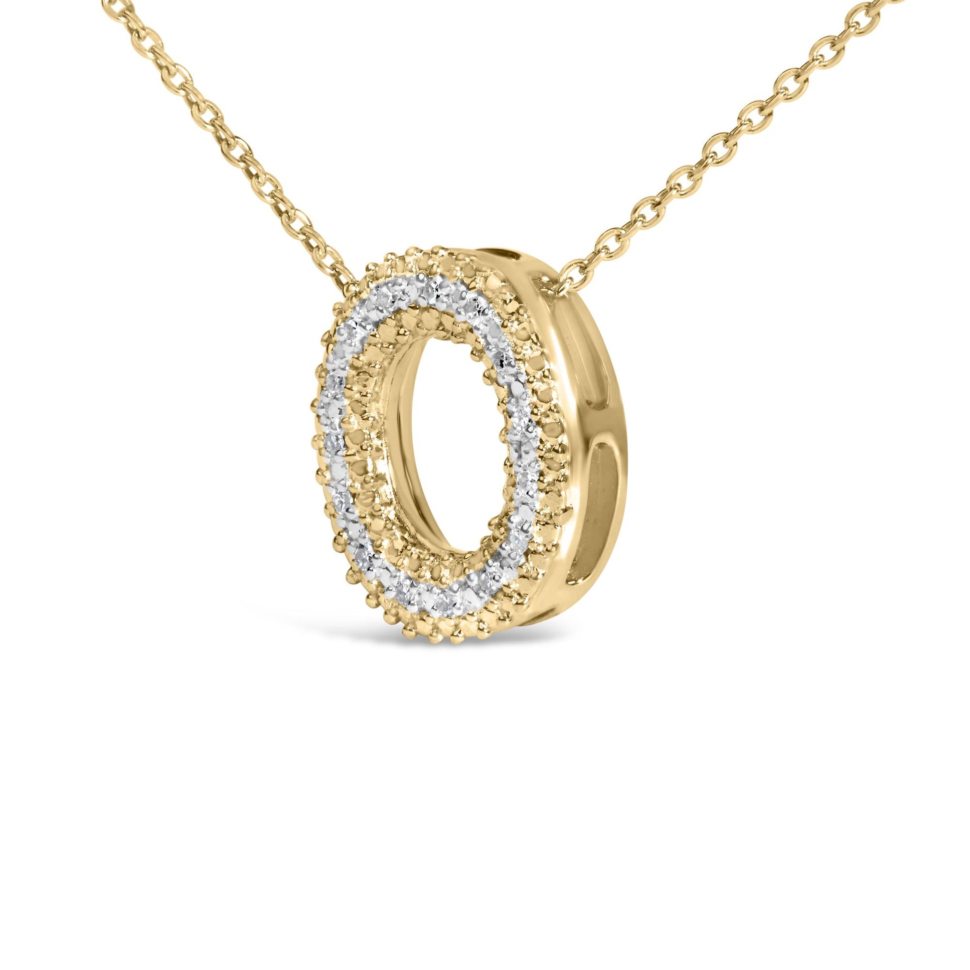 Close-up front angled view of a yellow metal necklace with an oval-shaped pendant outlined by small white gemstones in a prong setting.
