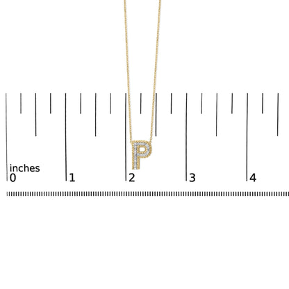 Close-up front view of a yellow necklace with a pendant in the shape of the letter 'P' set with white round gemstones, shown on a ruler scale.