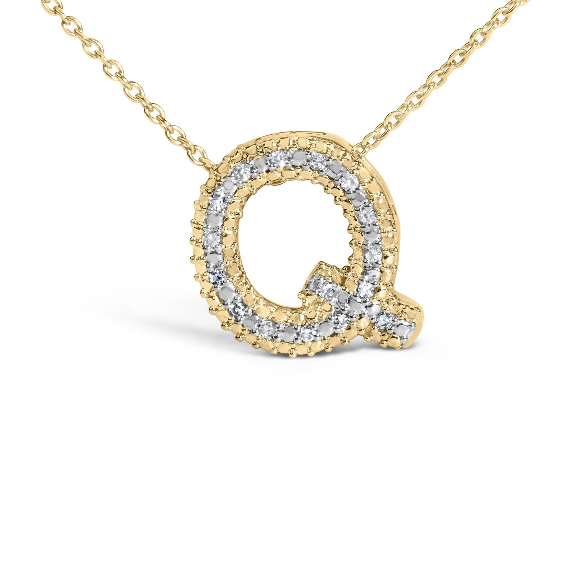 Close-up front angle of a yellow necklace pendant in the shape of the letter Q, adorned with round white gemstones in a prong setting along the outline.