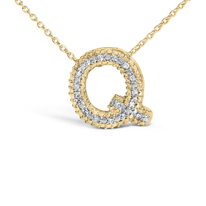 Close-up front angle of a yellow necklace pendant in the shape of the letter Q, adorned with round white gemstones in a prong setting along the outline.