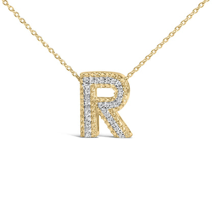 Close-up front view of a yellow necklace with a letter R pendant outlined and detailed with white gemstones in prong settings.
