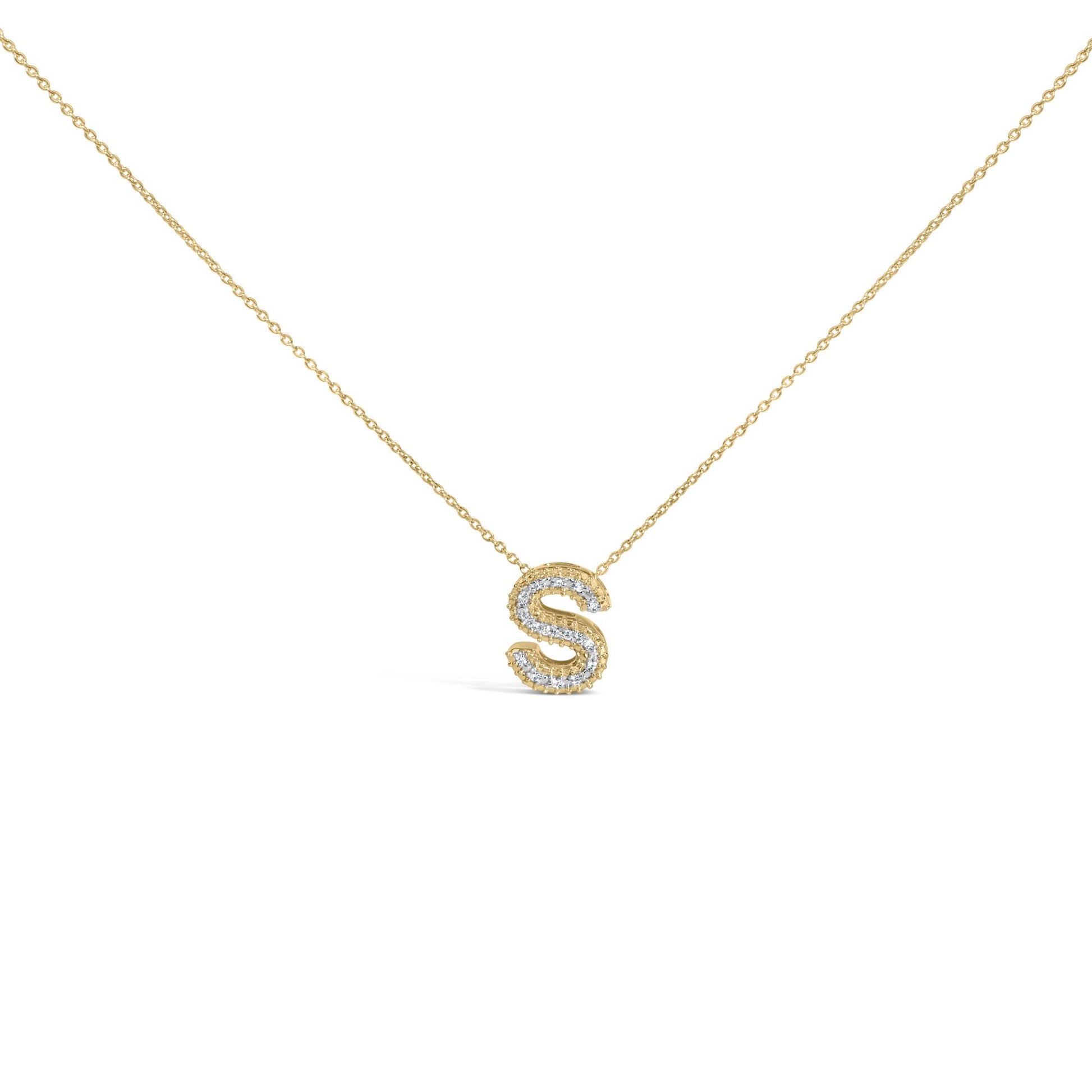 Close-up front view of a yellow necklace with a pendant shaped like the letter 'S' outlined with round white gemstones in prong settings.