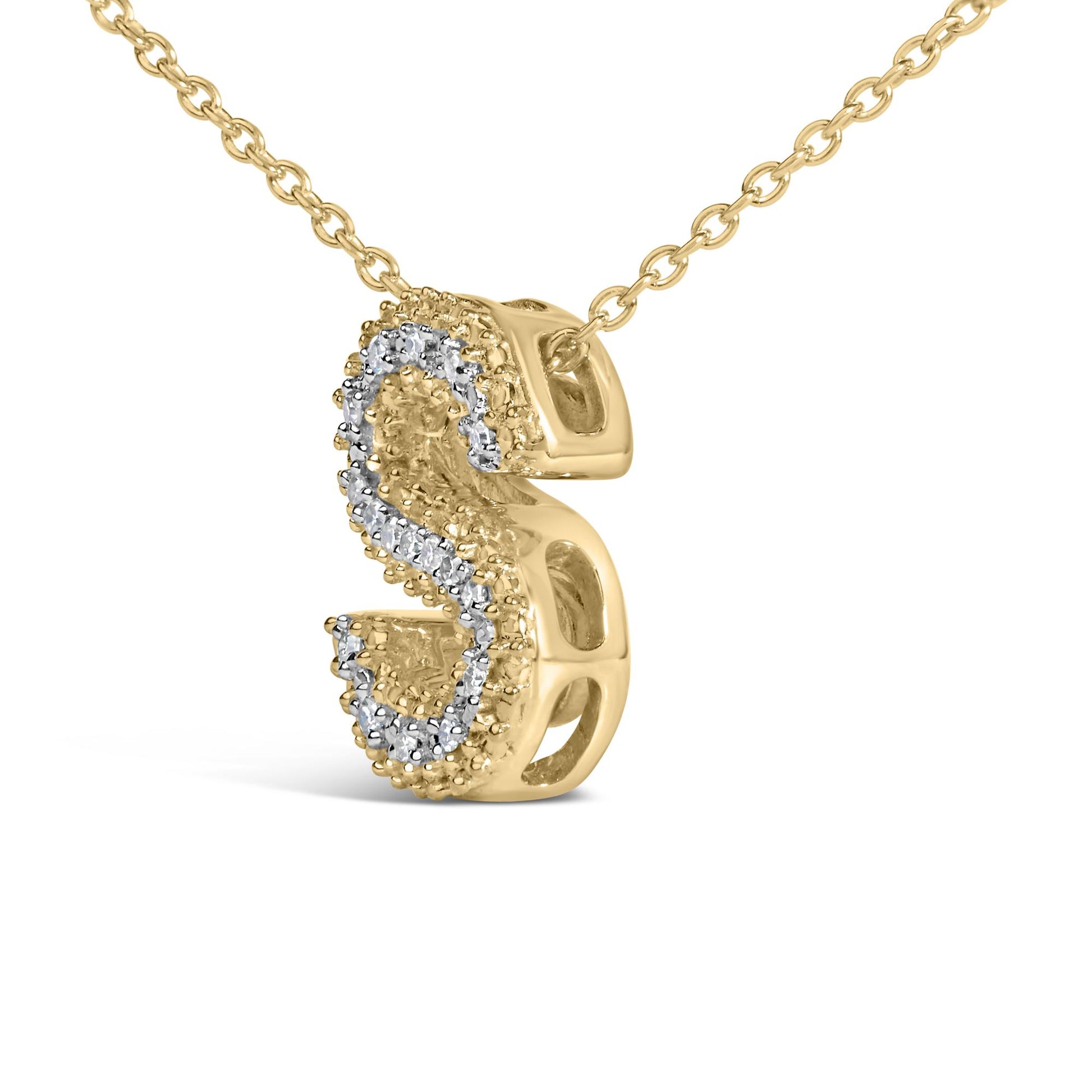 Close-up angled view of a yellow metal necklace with a pendant featuring a curved design outlined with small white gemstones in prong settings.