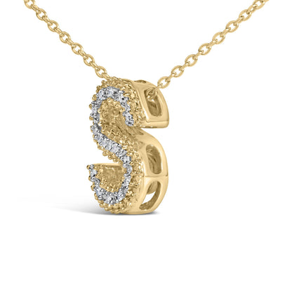 Close-up angled view of a yellow metal necklace with a pendant featuring a curved design outlined with small white gemstones in prong settings.