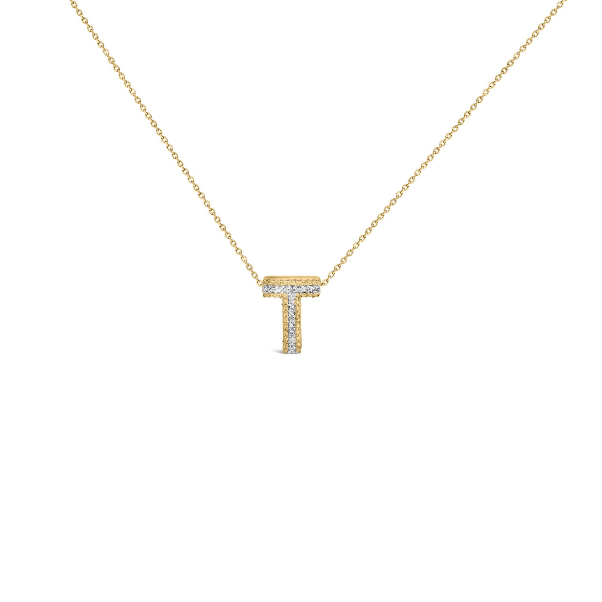 Close-up front view of a yellow metal necklace with a T-shaped pendant accented with small round white gemstones in prong settings.