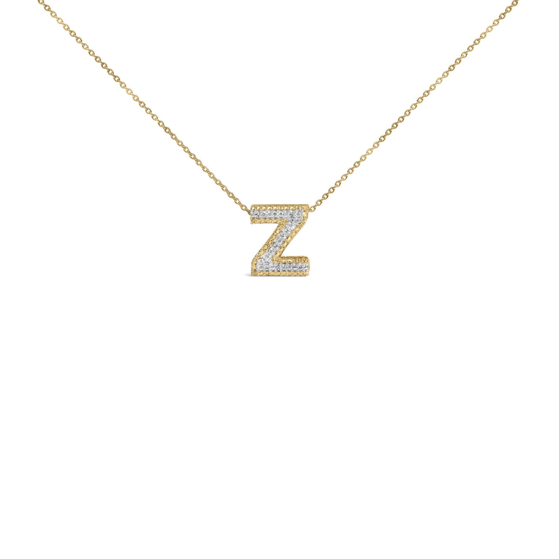 Close-up front view of a yellow metal chain necklace with a pendant in the shape of the letter Z, featuring white round gemstones in prong settings.
