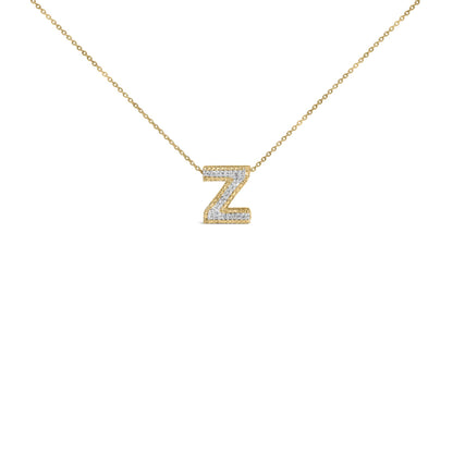 Close-up front view of a yellow metal chain necklace with a pendant in the shape of the letter Z, featuring white round gemstones in prong settings.