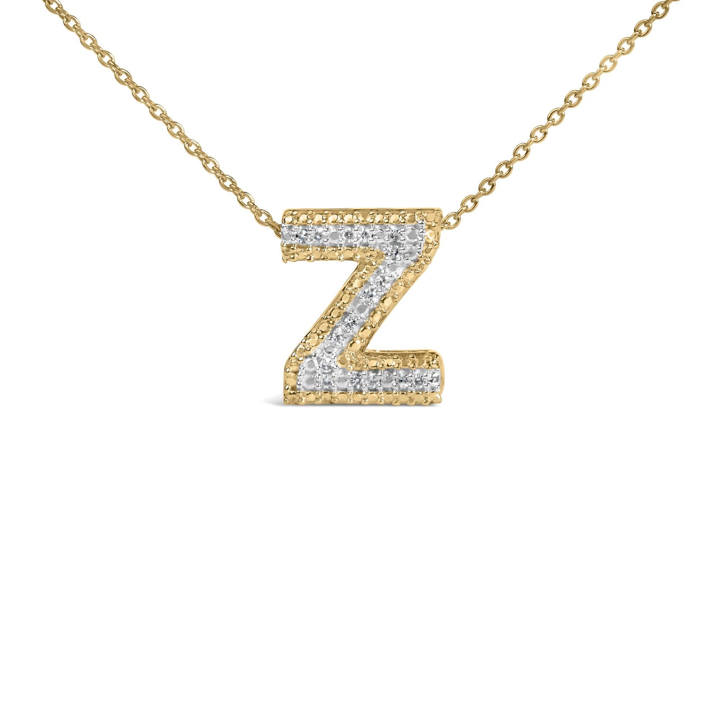 Close-up front angle of a yellow metal necklace with a pendant shaped like the letter Z, featuring white round gemstones in a prong setting along the center.