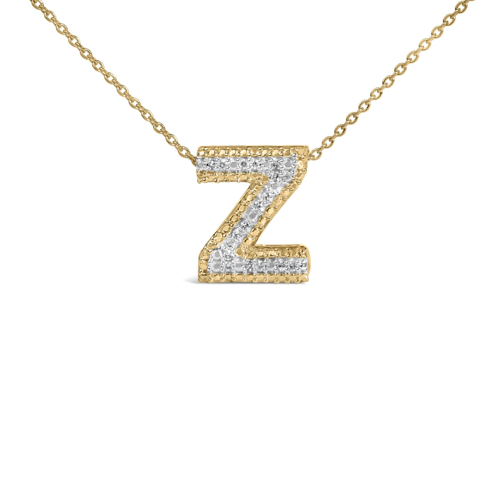 Close-up front angle of a yellow metal necklace with a pendant shaped like the letter Z, featuring white round gemstones in a prong setting along the center.