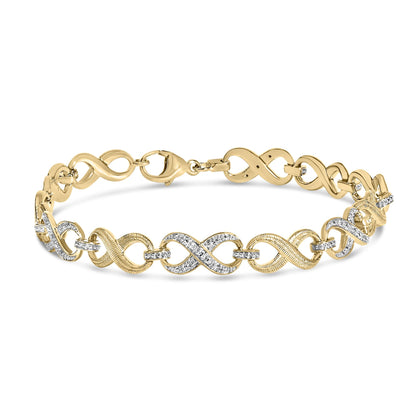 Yellow metal bracelet with intertwined loops, accented by white gemstones in a pave setting, shown in a close-up front angle on a white background.