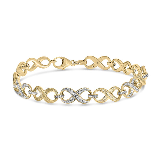 Yellow metal bracelet with intertwined loops, accented by white gemstones in a pave setting, shown in a close-up front angle on a white background.