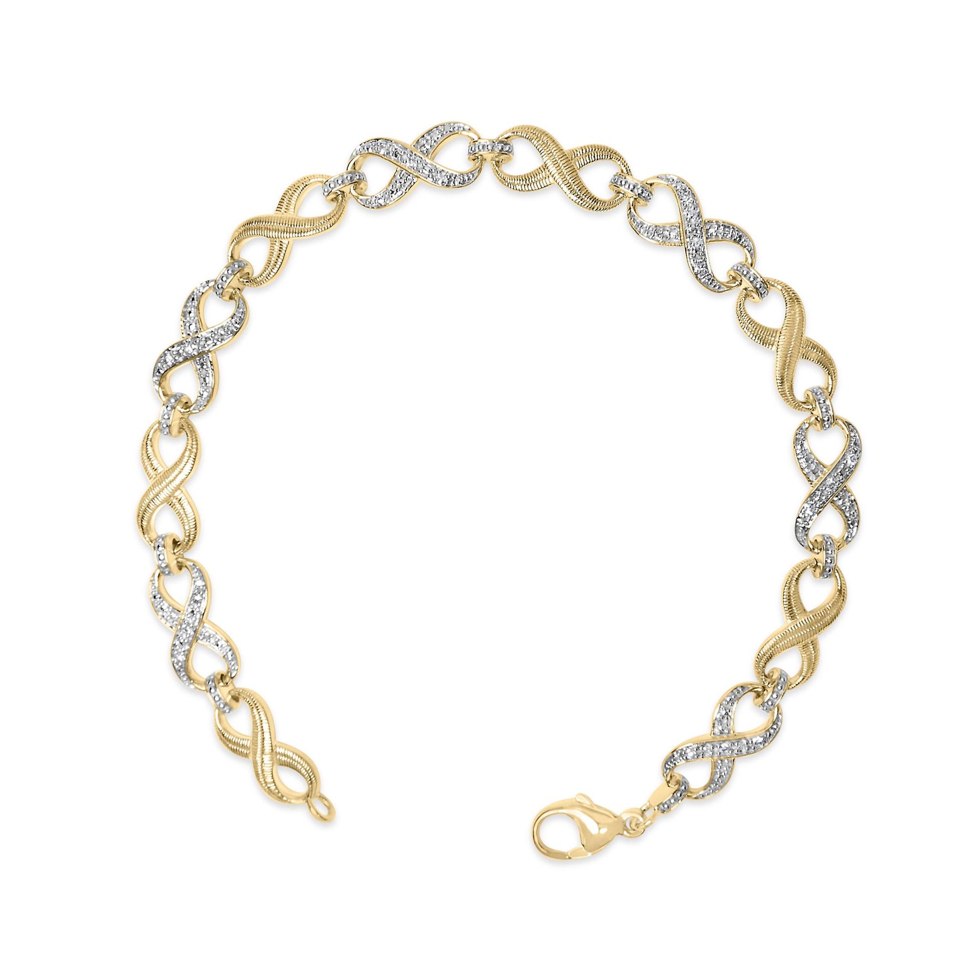 Yellow metal bracelet with alternating textured and pave-set white gemstone infinity links, lobster clasp, shown from top angle.