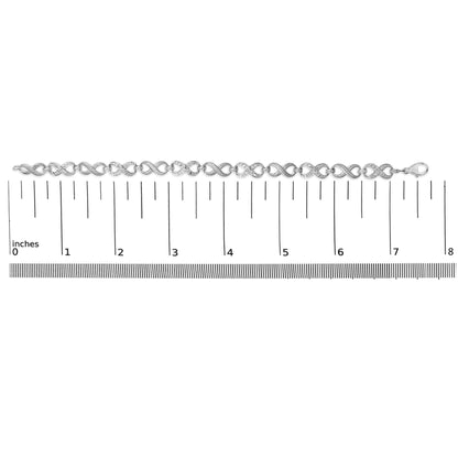 Bracelet shown on a scale in a top-down view, featuring linked figure-eight shapes alternating between smooth and pave-set white gemstones, with a lobster clasp on one end.