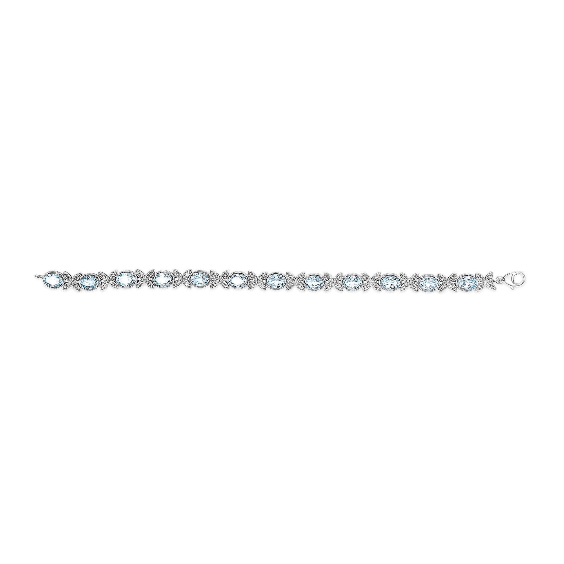 White metal bracelet with alternating oval blue gemstones and clusters of small round white gemstones, shown in a flat horizontal angle.