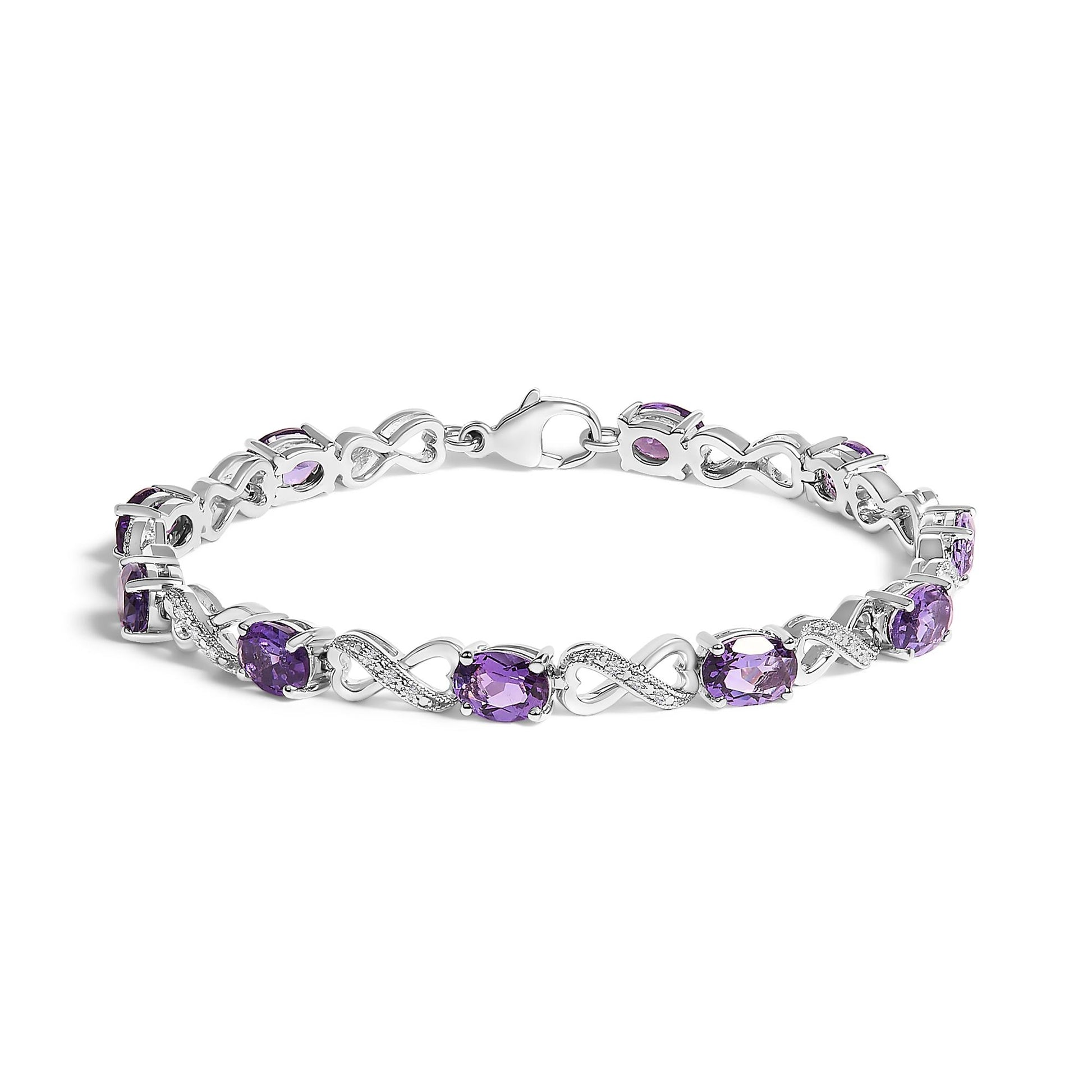 White metal bracelet with alternating purple oval gemstones and white round gemstones in infinity-shaped links, shown from a slightly elevated side angle.