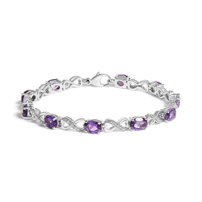 White metal bracelet with alternating purple oval gemstones and white round gemstones in infinity-shaped links, shown from a slightly elevated side angle.