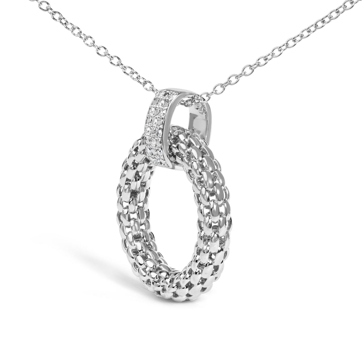 Close-up front angled shot of a white metal necklace with an interwoven loop pendant featuring a micro-pave setting of round white gemstones on one loop.