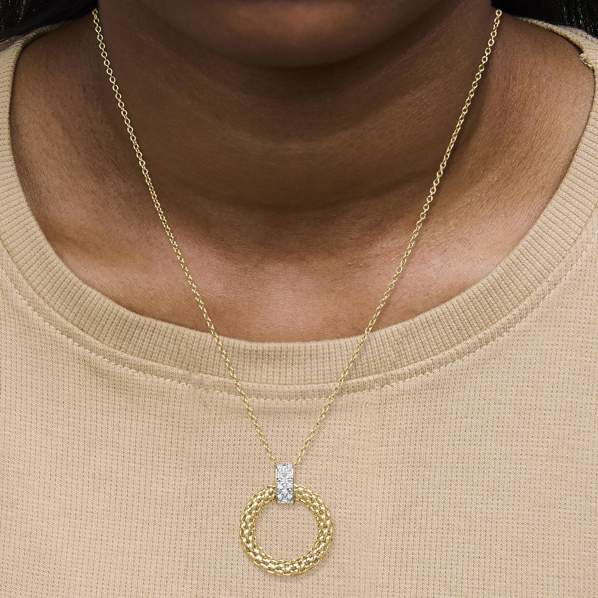 Close-up front of Gold Vermeil 1/10 Cttw Diamond Bold Pendant Necklace with round woven pendant and pave diamond bar on model