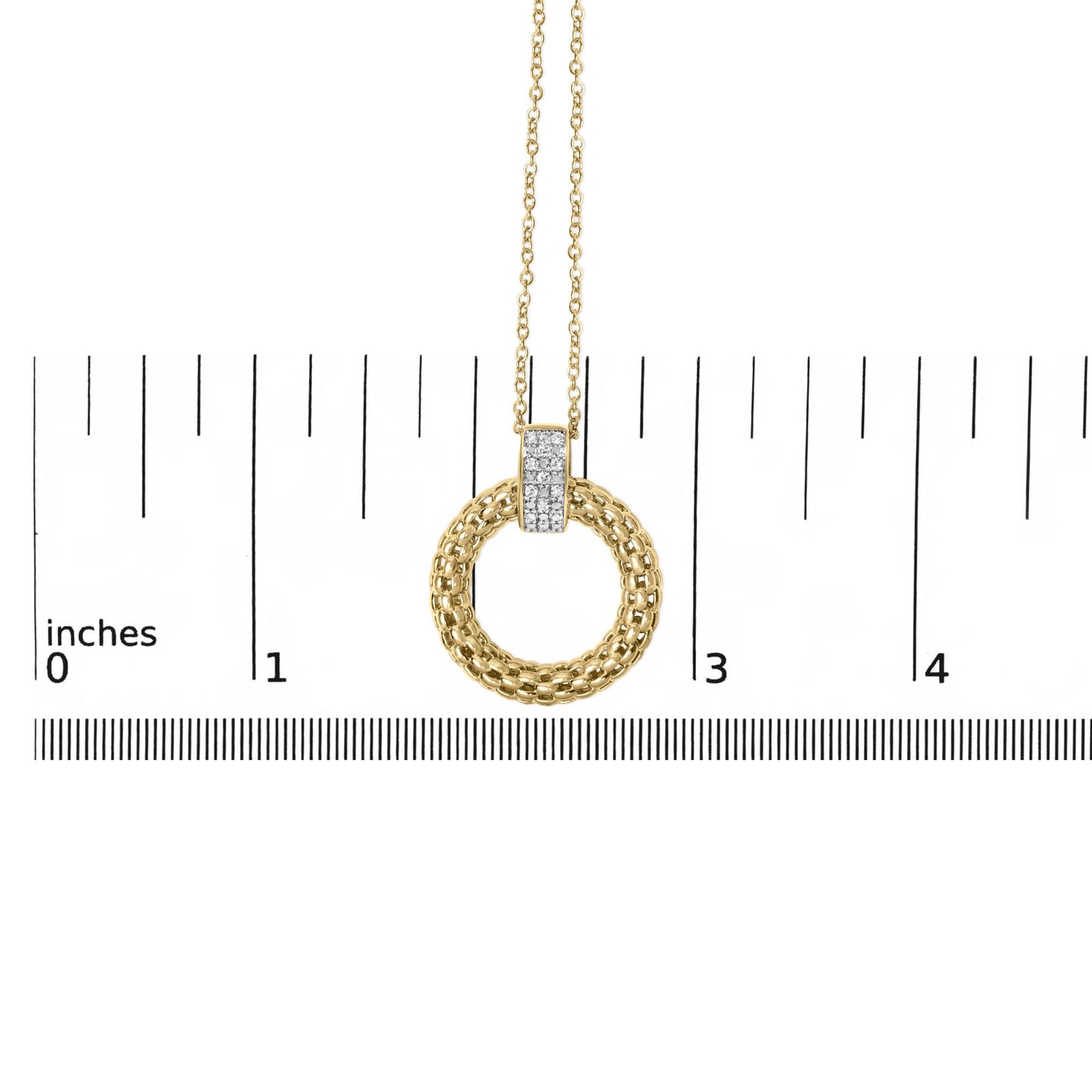 Front close-up of gold vermeil pendant showing braided circular ring and micro-pave diamond bar on inch ruler for scale