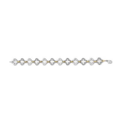Top-down view of a bracelet with alternating yellow and white metal links shaped like abstract flowers, each white link featuring multiple small white gemstones in a pave setting.
