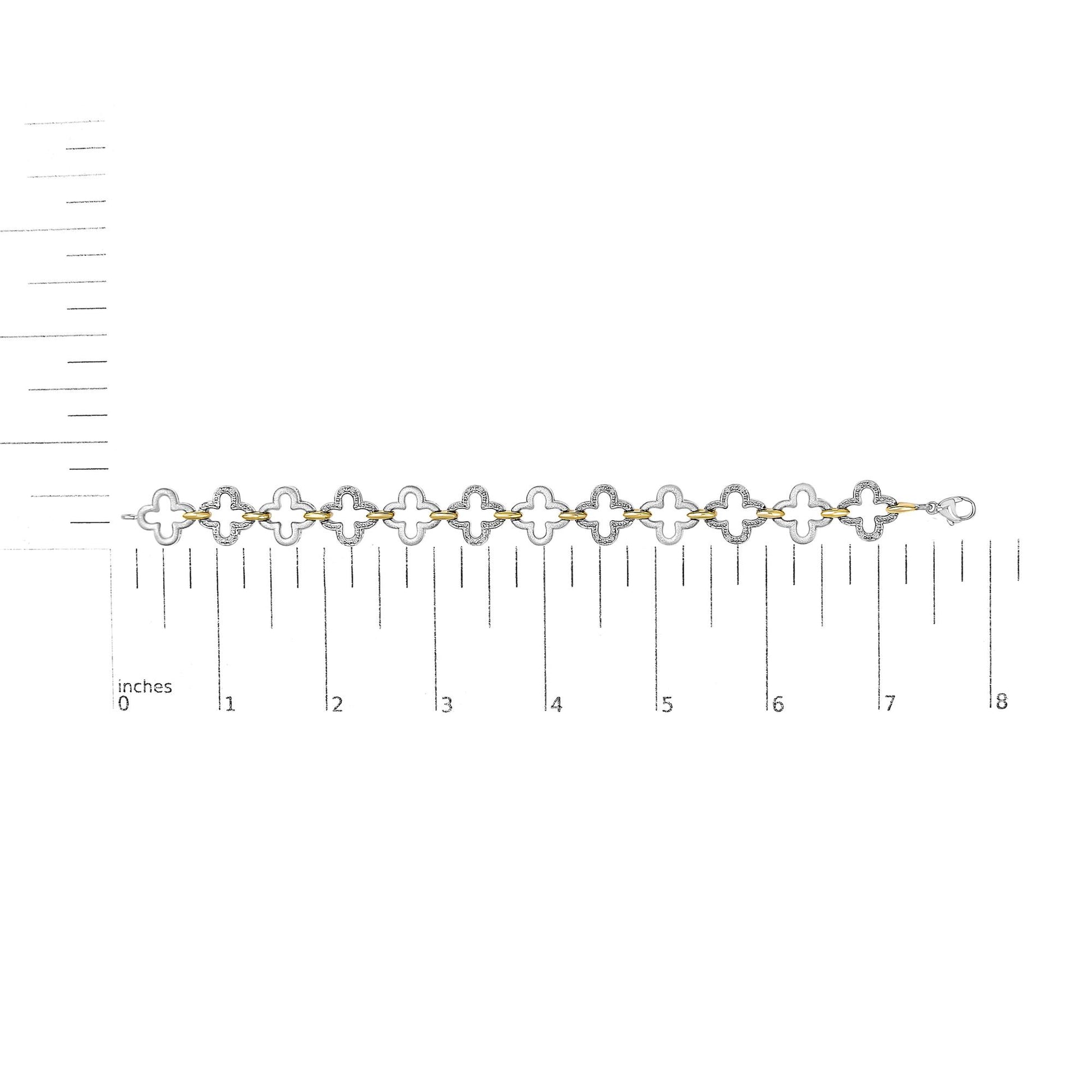 Bracelet with alternating yellow and white metal clover-shaped links, white gemstones in pave setting on white metal, shown flat on a scale from above.