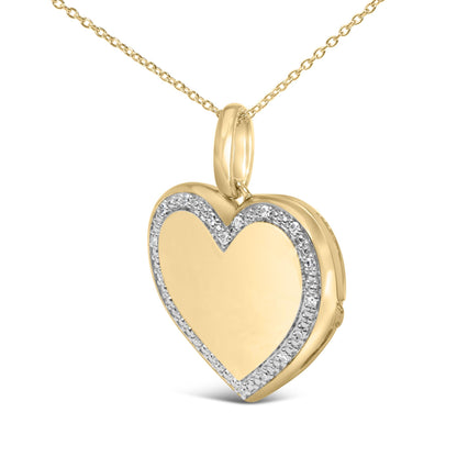 Close-up front angle of a yellow metal heart-shaped necklace pendant with a curved outline of white gemstones in a pave setting, shown against a white background.