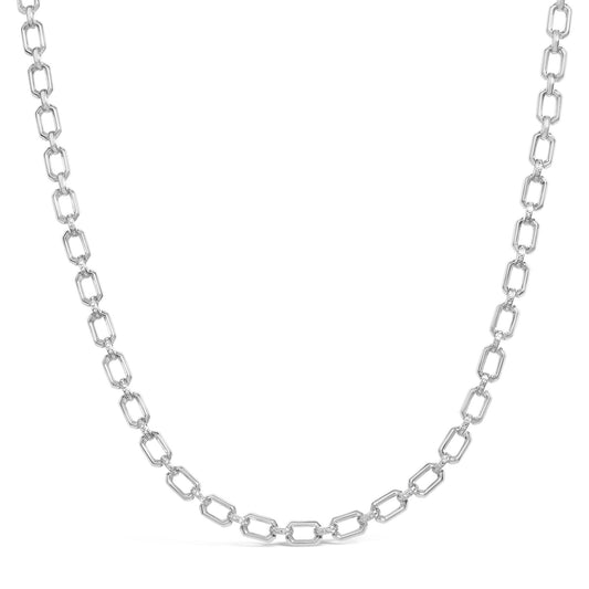 Close-up front view of a white metal necklace with rectangular links, some links accented with small white gemstones in a pave setting.