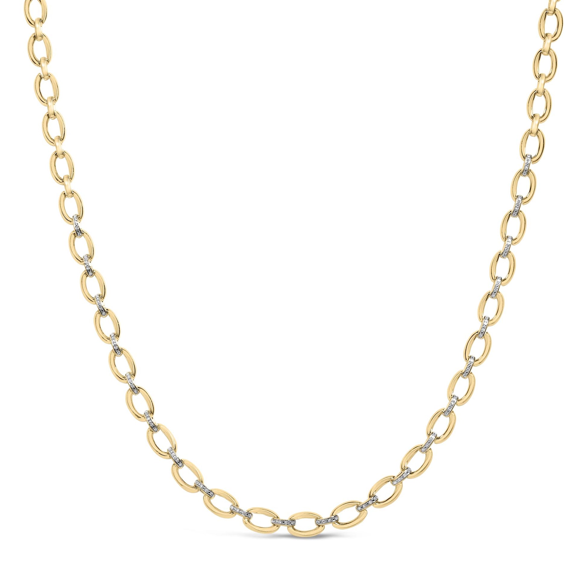 Close-up front angle of a yellow metal chain necklace with alternating links, some set with small white gemstones in a pave setting.