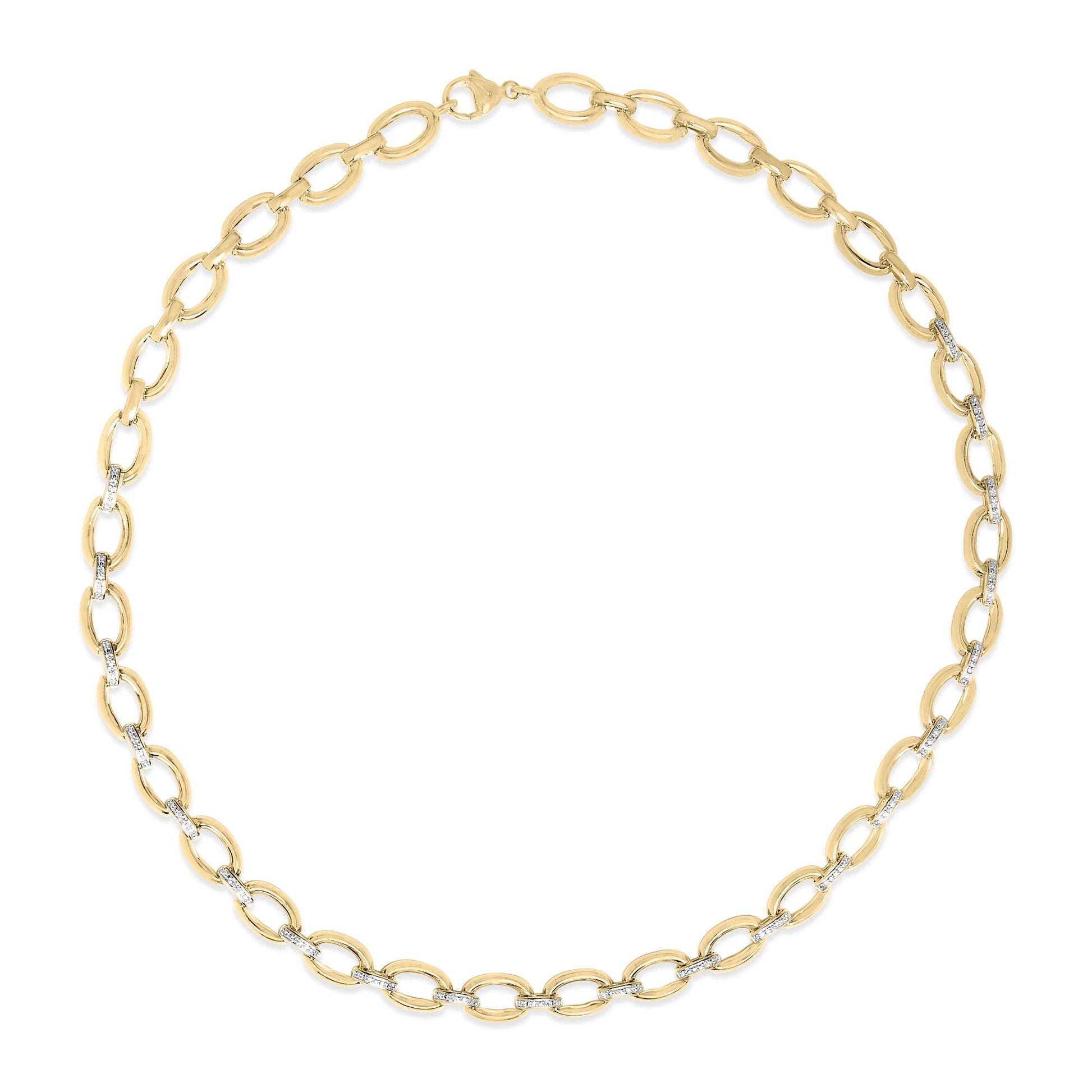 Close-up image of a yellow necklace with oval links, some links connected by bars set with white gemstones in a pave setting, shown from a top-down angle on a white background.