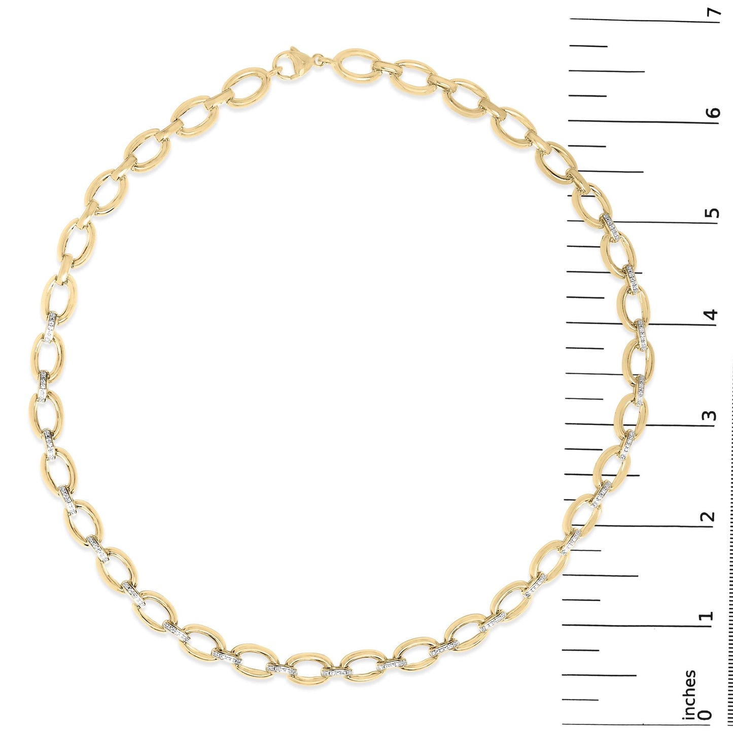 Yellow metal necklace with alternating plain oval links and oval links with pave-set white gemstones, shown on a scale, top view.