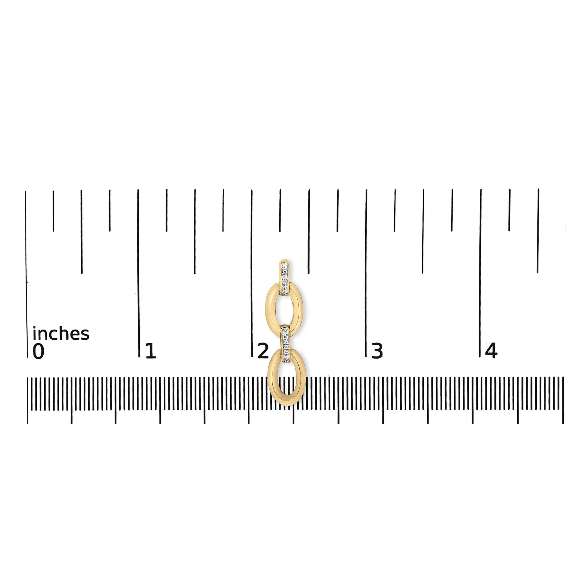 Close-up front view of gold vermeil diamond-accent oval link earring showcasing pave white stones on an inch ruler for scale