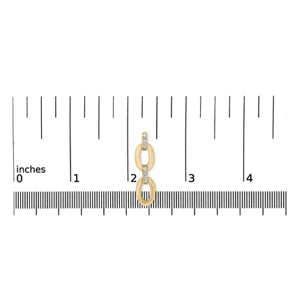 Close-up front view of gold vermeil diamond-accent oval link earring showcasing pave white stones on an inch ruler for scale
