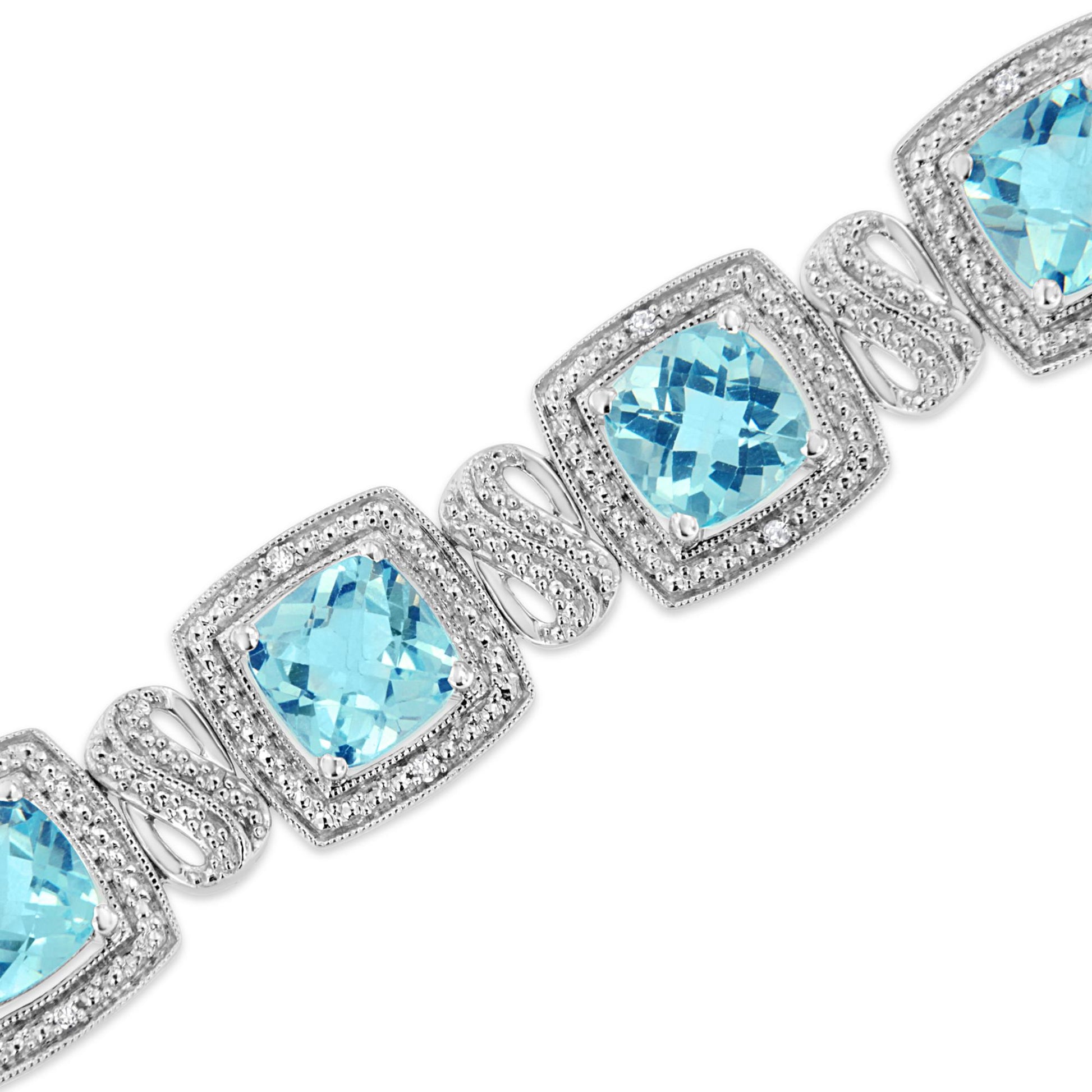 Close-up angle of a white metal bracelet featuring cushion-shaped blue gemstones prong-set in square frames, each surrounded by round white gemstones in pave settings, connected by decorative metal links.