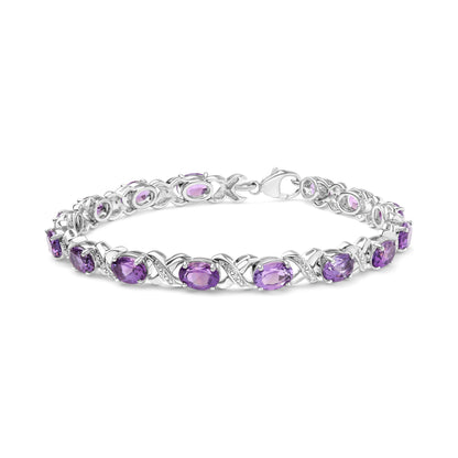 Bracelet in white metal with purple gemstones and white round gemstones in prong settings, shown in a close-up side angle.