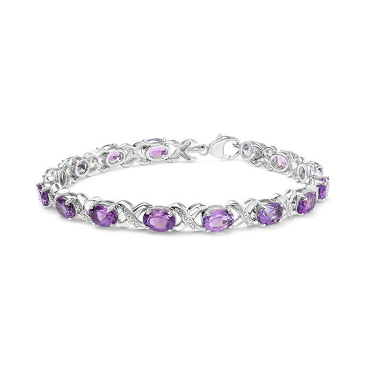 Bracelet in white metal with purple gemstones and white round gemstones in prong settings, shown in a close-up side angle.