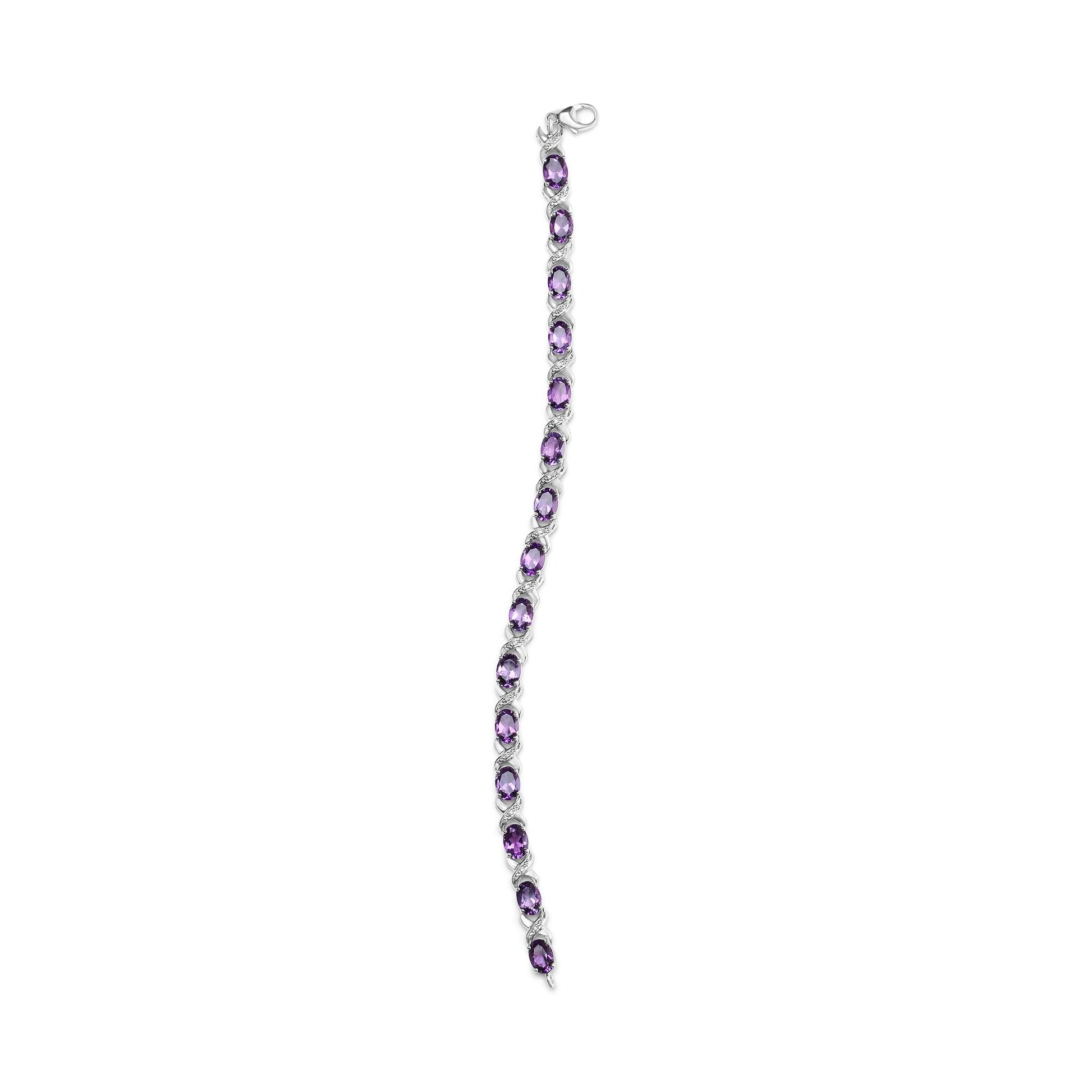 White metal bracelet with alternating purple and white gemstones in prong settings, shown flat from a top-down angle.