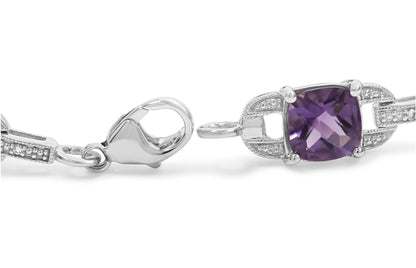 Close-up side view of a white metal bracelet clasp with a purple cushion-shaped gemstone set in prongs, flanked by white round gemstones in prong settings.