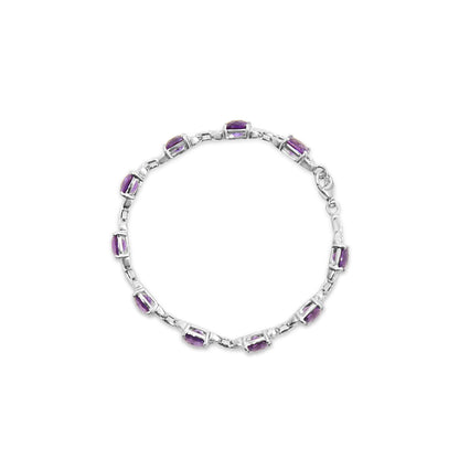Top-down view of a white metal bracelet featuring alternating round white gemstones and cushion-shaped purple gemstones in prong settings.
