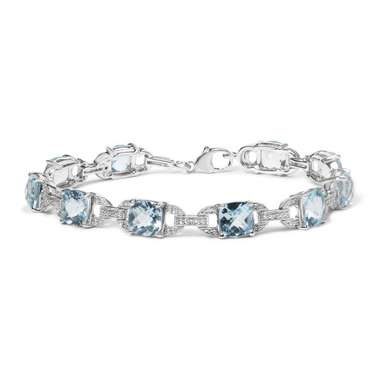 White metal bracelet with alternating round white gemstones and cushion-shaped blue gemstones in prong settings, shown in a front angled view.