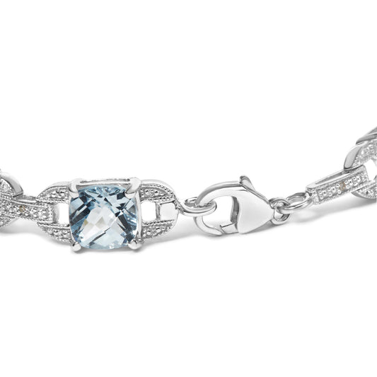 Close-up front angle of a white metal bracelet featuring a cushion-shaped blue gemstone and round white gemstones in prong settings, with a lobster clasp.